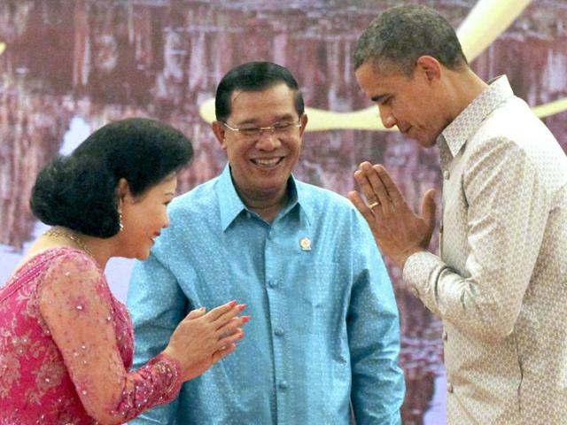 US President Barack Obama returns a greeting to Bun Rany, wife of Cambodian Prime Minister Hun Sen, prior to a gala dinner in Phnom Penh, Cambodia. AP