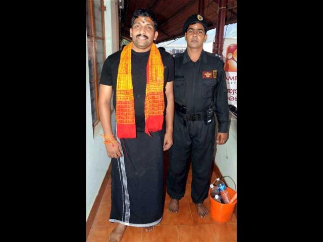NSG commando P V Maneesh, who was injured and paralysed during the 26/11 Mumbai terror attacks, visits Sabarimala temple after Kasab's execution. (PTI Photo)