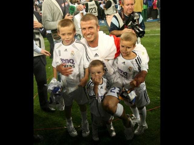 David Beckham poses with his sons after Real won the Spanish league title by beating Mallorca in the final Spanish league football match of the season, 17 June 2007 at the Santiago Bernabeu stadium in Madrid. Real won 3-1 to win their 30th league title. AFP Photo