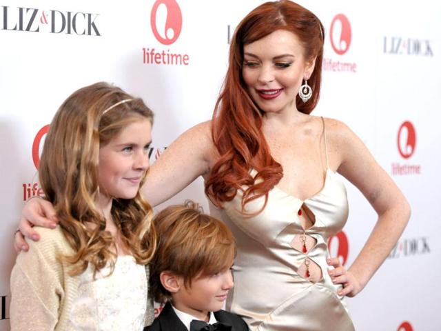 (From L-R) Actors Taylor Ann Thompson, Trevor Thompson and Lindsay Lohan attend a dinner celebrating the premiere of Liz & Dick at the Beverly Hills in Beverly Hills, California.