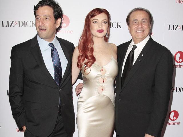 Lifetime executive vice president of programming Rob Sharenow, (L-R) actress Lindsay Lohan and executive producer Larry Thompson arrive for a private dinner celebrating the upcoming premiere of Liz & Dick at the Beverly Hills Hotel in Beverly Hills, California.