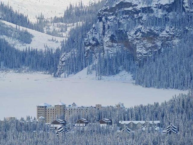 Jamie, hotel worker, of Fairmont Chateau Hotel shovels a snow between the hotel and a gateway to the Lake Louise early morning in Lake Louise, Alberta. AFP Photo