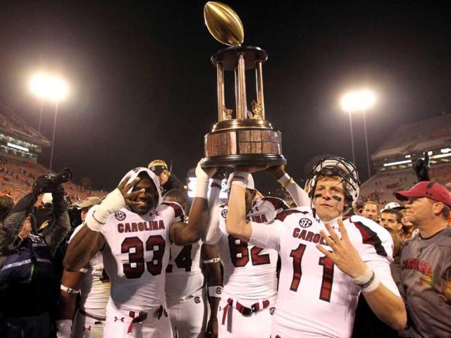 Seth Strickland #11 of the South Carolina Gamecocks and teammate Damario Jeffery #33 celebrate after defeating the Clemson Tigers 27-17 after their game at Memorial Stadium in Clemson, South Carolina. AFP Photo