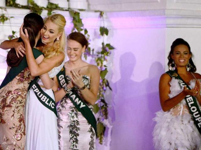 2012 Miss Earth winner Tereza Fajksova of Czech Republic (2nd L) hugs 2012 Miss Air Stephany Stefanowitz (L) of the Philippines after she won the 2012 Miss Earth Competition in Manila. AFP photo