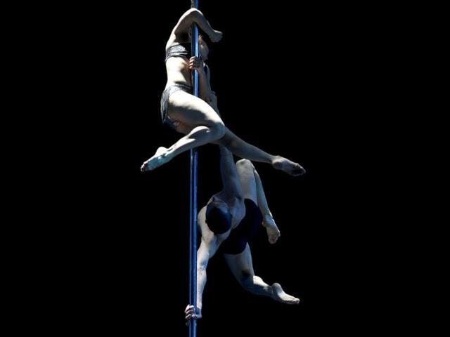 Argentine pole dancers Belen Serra and Joaquin Dazzotti compete to win first place in the Pole Dance South America 2012 competition in Buenos Aires. (AFP Photo)