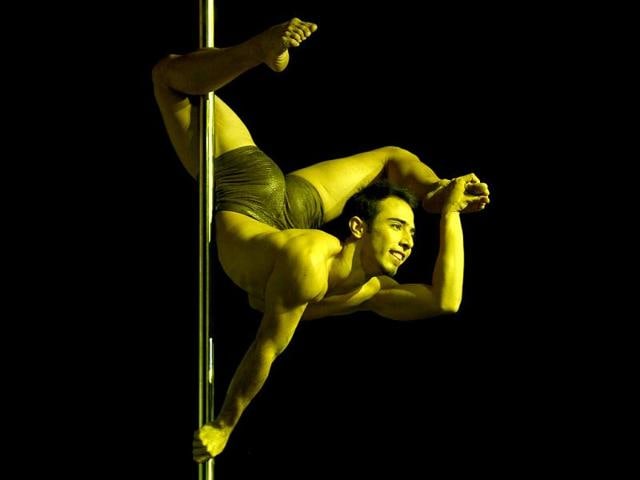 Pole dancer Gregoris Garcia of Venezuela competes in the Pole Dance South America 2012 competition in Buenos Aires. (AFP Photo)