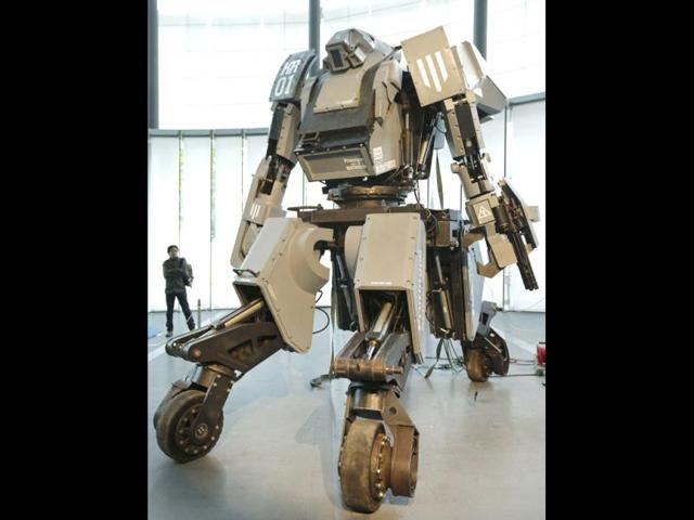 A man looks at a giant "Kuratas" robot at an exhibition in Tokyo. The four-meter-high, limited edition, made-to-order robot is controlled through a pilot in its cockpit, or via a smartphone. Reuters Photo