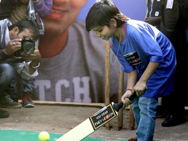 A child bats as cricketer Gautam Gambhir bowls during a Hindustan Times initiative 'You Read They Learn' programe at Pratham centre at Trilokpuri in New Delhi. HT/Arijit Sen