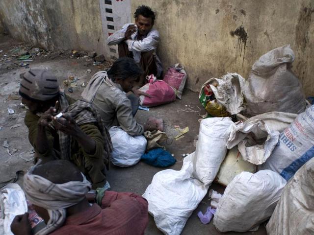 Drug users sort out recycling wastes which pays for their habit in the old sector of New Delhi. AFP/Anna Zieminiski