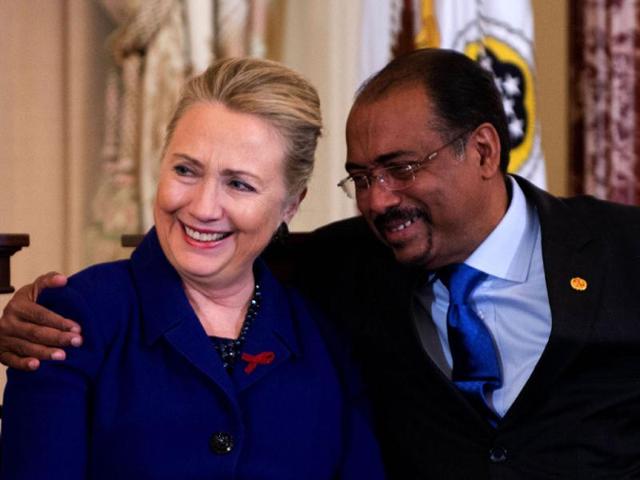 US secretary of state Hillary Clinton (L) is hugged by United Nations Aids Executive Director Michel Sidibe during an event in recognition of World AIDS Day at the State Department in Washington, DC. AFP/Jim Watson