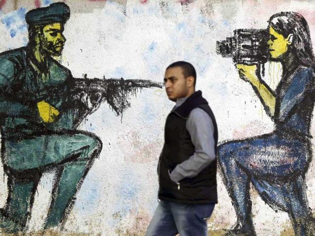 A man walks past murals at Mohamed Mahmoud street in Cairo. Reuters/Amr Abdallah Dalsh