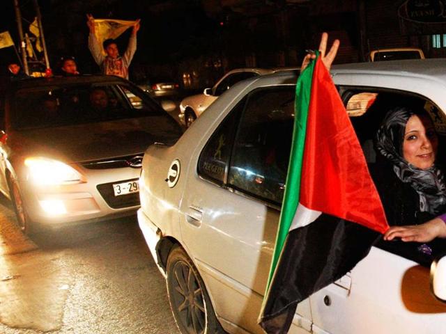 Palestinians celebrate the UN General Assembly votes on a resolution to upgrade the status of the Palestinian Authority to a nonmember observer state, along the streets of Gaza City. The UN General Assembly has voted by a more than two-thirds majority to recognize the state of Palestine upgrading its status to a non-member observer state at the United Nations. AP