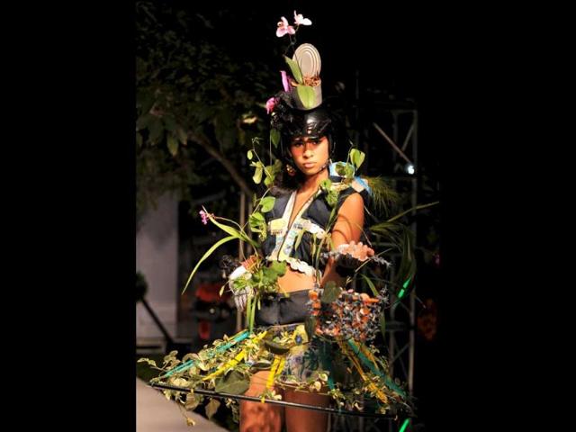 A model presents designs made with natural materials and live plants during the Bio Fashion Tropico Show in Colombia. (AFP/ Luis Robayo)