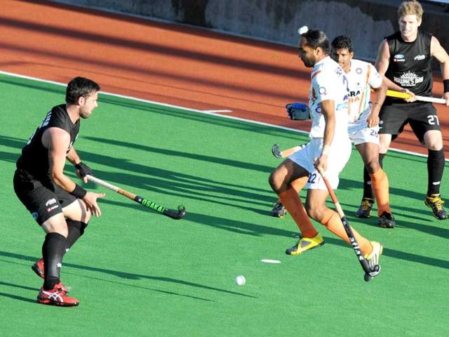 Sandhu Habir Singh leaps to avoid the ball fired by Matt L'Huillier of New Zealandduring their Pool A match at the Men's Hockey Championships Trophy in Melbourne. (AFP Photo)