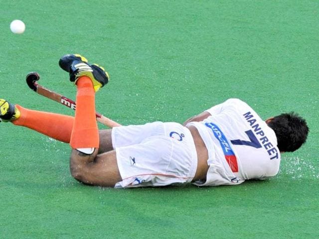 Manpreet Singh of India slides as he makes a pass during their Pool A match against New Zealand at the Men's Hockey Championships Trophy in Melbourne. (AFP Photo)