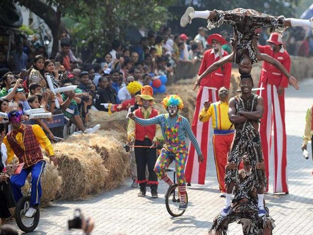 Crowd looks on as an acrobat team performs during India's first RedBull Soapbox Race in Mumbai. Soapbox racing is popular in western countries. AFP Photo