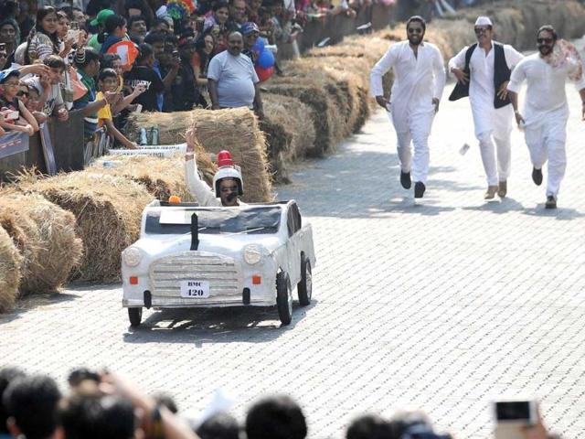 A soapbox team driver raises his hand during India's first Soapbox Race in Mumbai. Soapbox racing is a non-motorised racing event where the task is to design and build imaginative, human-powered soapbox machines and compete against the clock on a downhill race course featuring jumps, bumps and curves. AFP Photo