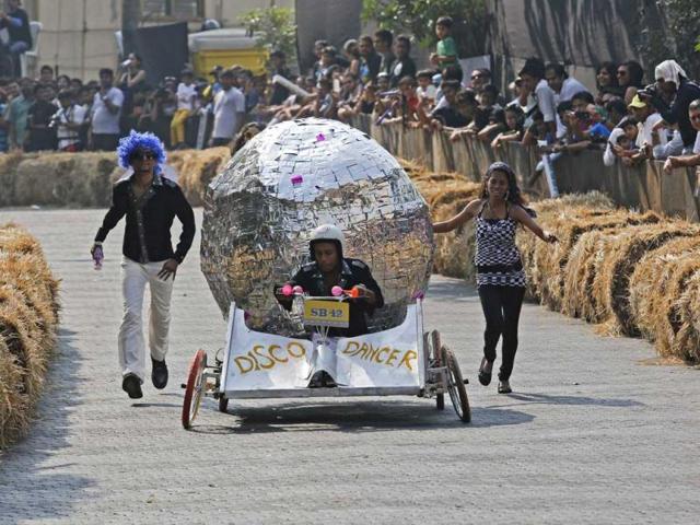 A contestant rides a home-made disco ball shaped vehicle without an engine down a hill during the Red Bull Soapbox Race in Mumbai. The race is judged on speed, creativity and showmanship, with competitors having to navigate their home-made human powered vehicles on the track in the best time. Reuters Photo