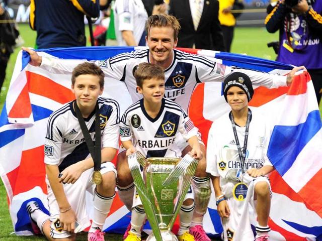 David-Beckham-poses-with-his-sons-Brooklyn-L-Cruz-C-and-Romeo-and-the-MLS-Trophy-after-the-Los-Angeles-Galaxy-beat-Houston-Dynamo-3-1-in-the-Major-League-Soccer-MLS-Cup-in-Carson-California-It-was-Beckham-s-last-game-with-the-Galaxy-AFP-Photo
