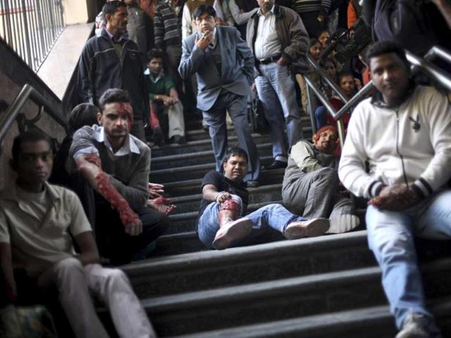 Volunteers pretending to be bomb blast victims, sit on the stairs of a metro station during a mock drill session in New Delhi. AP Photo