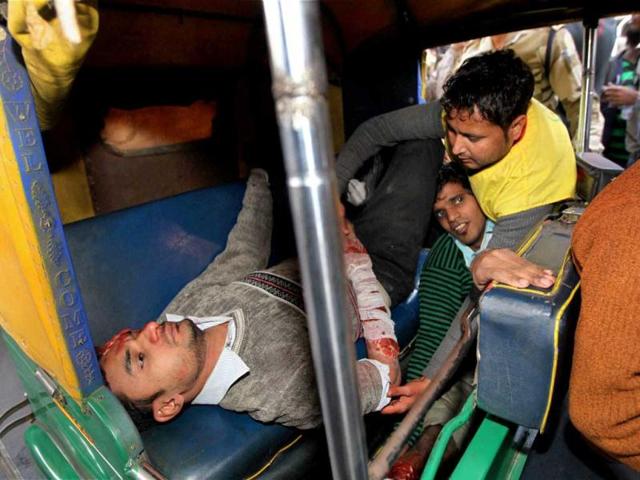 Volunteers pretending to be injured persons are taken away in an auto-rickshaw during a mock drill session at Jhandewalan Metro Station in New Delhi. PTI Photo