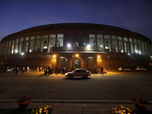 An official's car drives past Parliament House in New Delhi. Congress led government won a crucial vote in favor of its decision to open up the country's huge retail sector to foreign big-box companies like Wal-Mart, a move that its opponents said will crush small shop owners and farmers. (AP Photo)