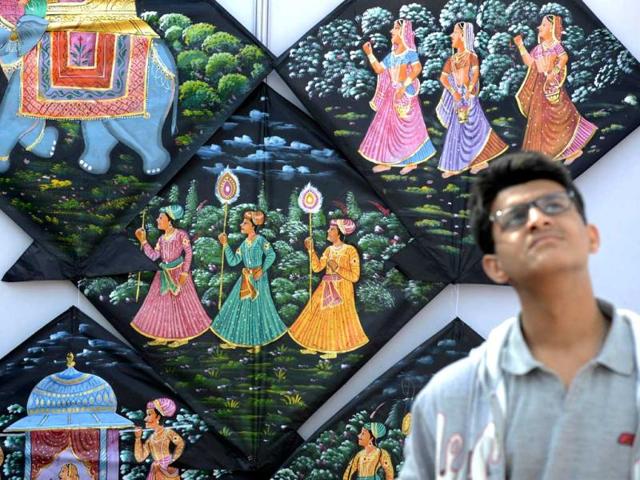 An Indian youth watches kites fly during the two-day International Kite Festival that started today at the lawns of the India Gate monument. (AFP/ Photo)
