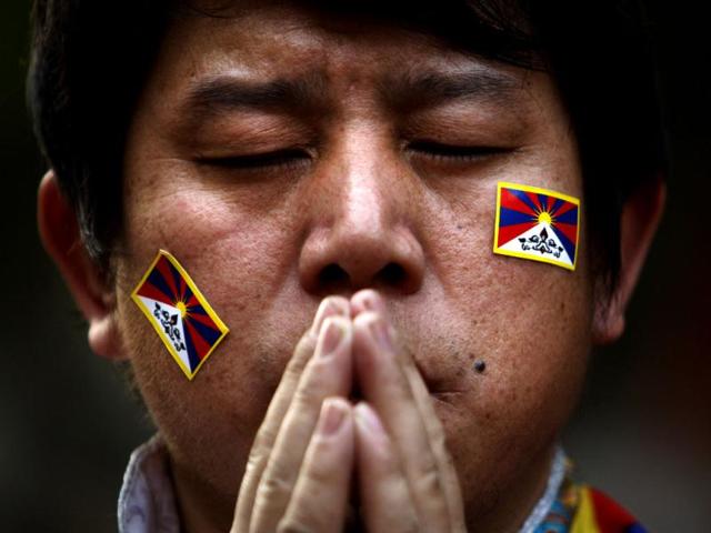 An exiled Tibetan Buddhist man prays during a rally to mark World Human Rights Day in New Delhi. At least 86 people have set themselves on fire since 2009. Tibetans also mark December 10 as the Nobel Peace Prize Day, the day the Dalai Lama received the Nobel peace prize in 1989. (AP Photo/Tsering Topgyal)