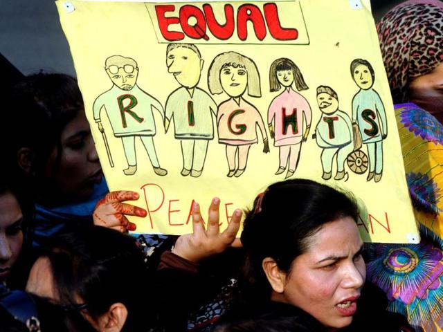 Pakistani NGOs activists carry placards as they shout slogans at an event on International Human Rights Day in Lahore. The father of Malala Yousafzai, the Pakistani girl shot by the Taliban for campaigning for girls' education, has been named a UN special advisor on global education, UN envoy Gordon Brown said. AFP PHOTO/ARIF ALI