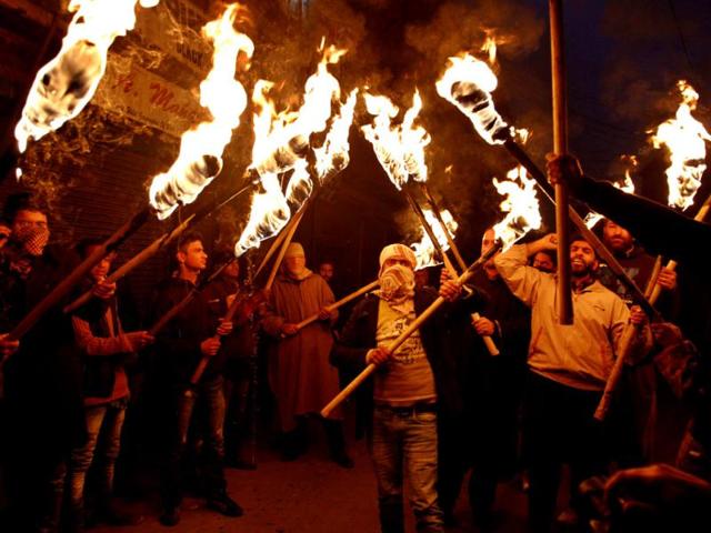 Activists and supporters of Jammu and Kashmir Liberation Front (JKLF) hold torches as they participate in a protest march to mark International Human Rights Day in Srinagar. More than 68,000 people, mostly civilians, have been killed since the outbreak of the insurgency in the region in 1989. Pakistan, Kashmiri separatist leaders and human rights groups have been demanding a reduction in India's military presence in Kashmir. (AP Photo/Mukhtar Khan)