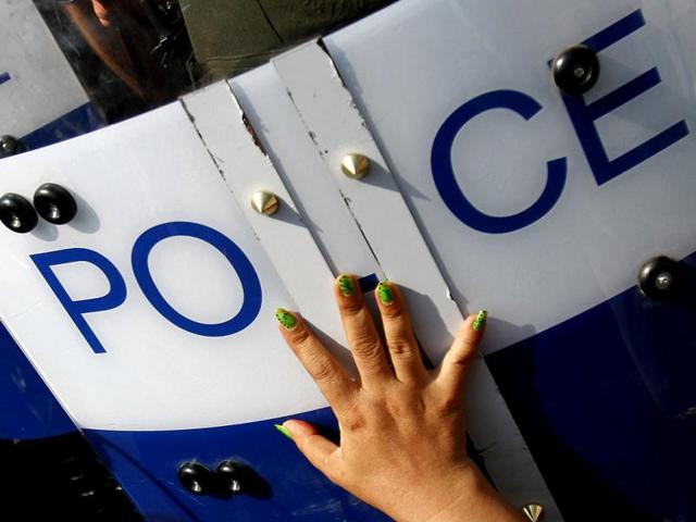 A woman from the Boeung Kak lake community touches a police shield during a march to celebrate the 64th anniversary of Human Rights Day in Phnom Penh. Boeung Kak lake residents, who are embroiled in land disputes, gathered to celebrate the 64th Human Rights Day and to appeal to Cambodian Prime Minister Hun Sen for help in their threatened eviction from land to make way for the development of luxury private property. REUTERS/Samrang Pring