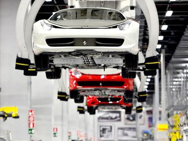 Ferrari tourism cars are held with pincers on the assembly line of the Ferrari factory in Maranello. The Ferrari 45 buildings's factory, where more than 3,000 workers produce the company’s GT and Formula 1 cars is based in Maranello. AFP Photo