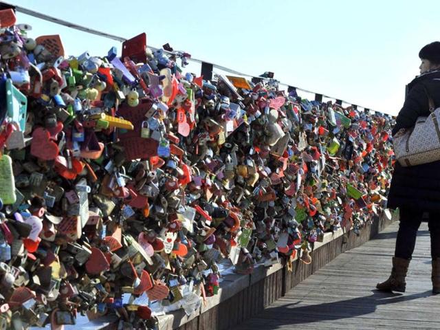 A woman looks "locks of love" hanging on the wall of a terrace of the N Seoul Tower on the top of Nam mountain in Seoul. AFP Photo
