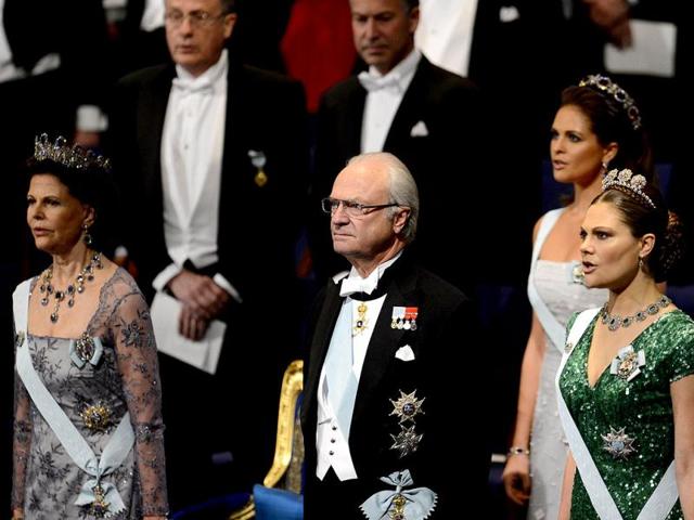 Queen Silvia of Sweden (2dL) and King Carl Gustaf of Sweden (L), Princess Victoria of Sweden (R) and Princess Madeleine of Sweden (2d row R) sing the national anthem at the start of the Nobel prize awarding ceremony at the Stockholm Concert Hall in Stockholm, Sweden. AFP PHOTO/JONATHAN NACKSTRAND