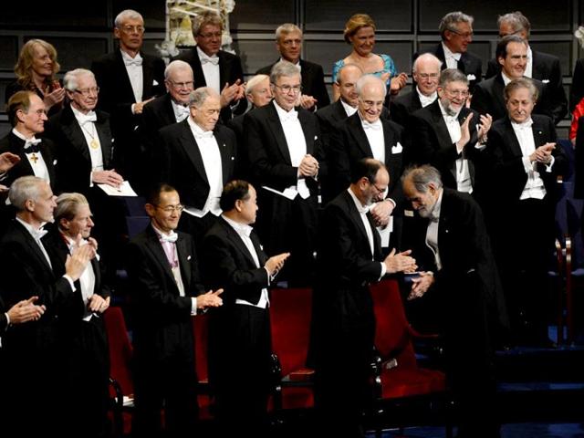 (1st row L-R) The Nobel 2012 Chemistry laureate Brian K Kobilka, the Nobel 2012 Physiology or Medecine laureates John B Gurdon of England and Shinya Yamanaka of Japan, the 2012 Nobel Literature Prize winner Mo Yan of China applaud the 2012 Nobel laureates in Economics Alvin E. Roth and Lloyd S. Shapley at the Nobel prize awarding ceremony in Stockholm. The winners of the Nobel Prize 2012 in the categories of medicine, physics, chemistry, literature and economics receive their awards from the hands of Sweden's King Carl XVI Gustaf at a formal ceremony, followed by a gala banquet. AFP PHOTO/JONATHAN NACKSTRAND