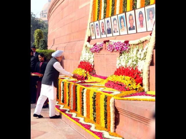 Prime Minister Manmohan Singh pays tribute to the martyrs of the 2001 Parliament attack on its 11th anniversary, at Parliament House in New Delhi. (PTI Photo)