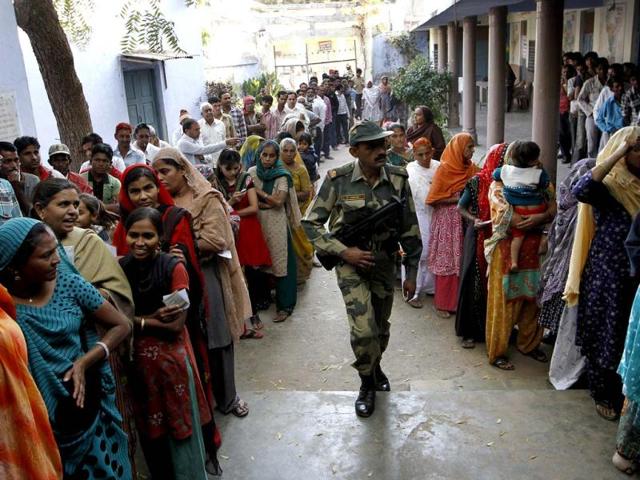 Voters standing in queue during the first phase polling of Gujarat assembly election in Ahmedabad, Gujarat. HT/Arijit Sen