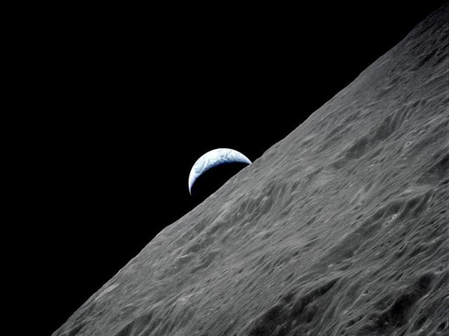 The crescent Earth rises above the lunar horizon in this NASA photograph taken from the Apollo 17 spacecraft in lunar orbit during the final lunar landing mission in the Apollo program. (Reuters Photo/NASA)