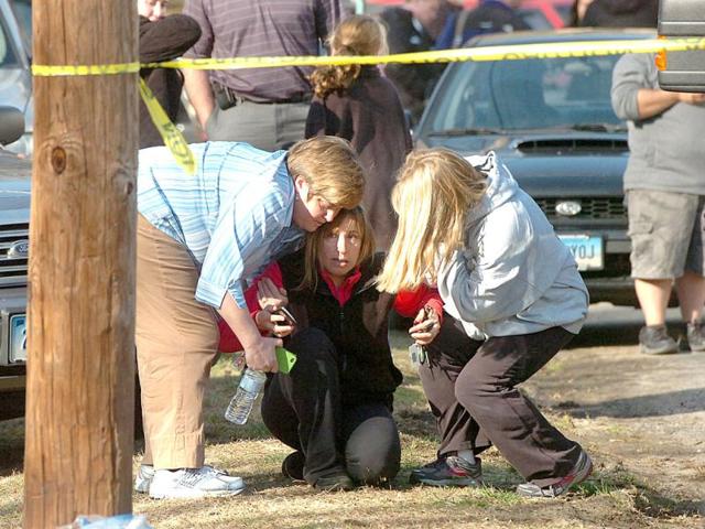 People are comforted near Sandy Hook Elementary School in Newtown, Connecticut. AP photo
