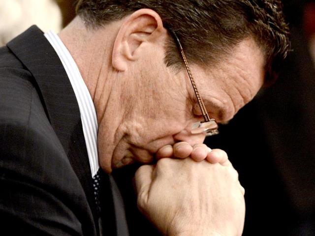 Connecticut governor Dannel Malloy bows his head during a moment of silence during a vigil service for victims of the Sandy Hook Elementary School shooting, at the St. Rose of Lima Roman Catholic Church in Newtown, Connecticut. AP photo