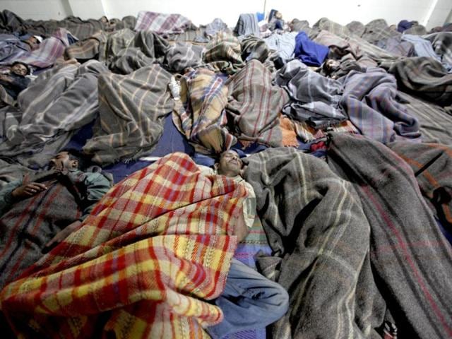Homeless people sleeping in the "rain basera" night shelter at the Old Delhi Railway station in Old Delhi. HT photo/Raj K Raj