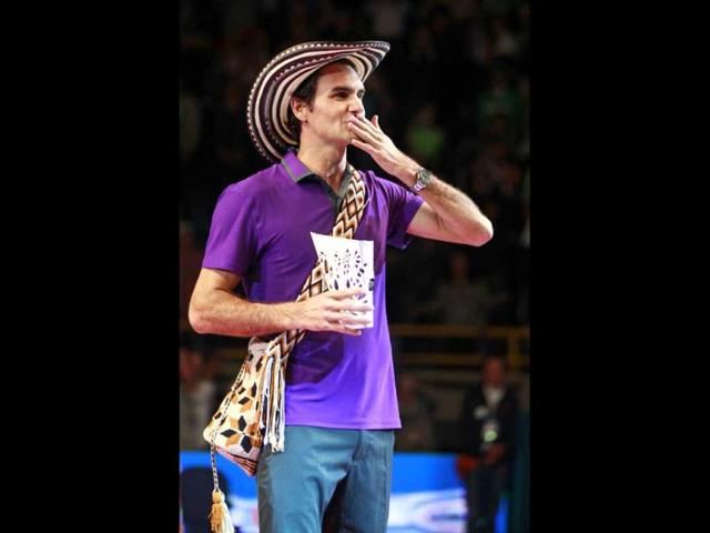 Roger Federer of Switzerland, wearing a Colombian Vueltiao, blows a kiss while holding his trophy after beating Jo-Wilfried Tsonga of France in an exhibition tennis match in Bogota. Reuters