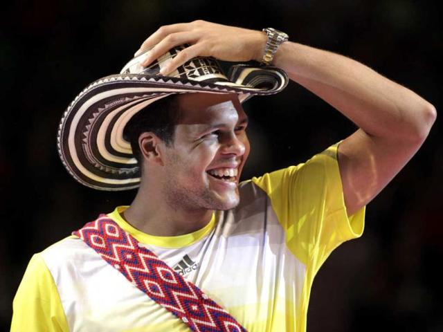 France's tennis player Jo-Wilfried Tsonga smiles as he wears a traditional Colombian hat after an exhibition match against Switzerland's Roger Federer in Bogota, Colombia. AP photo