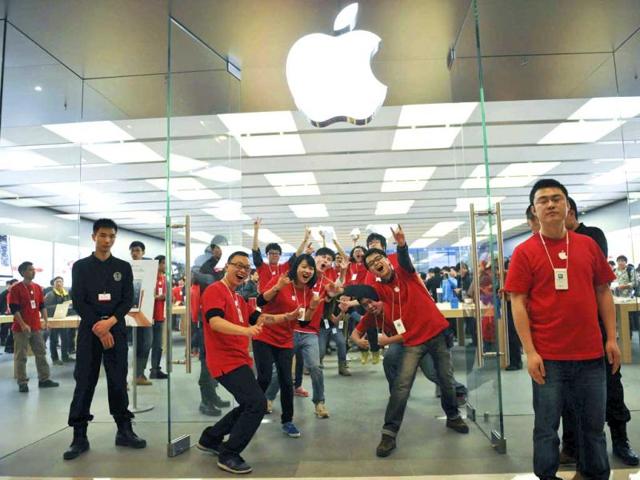Chinese employees pose for photographers at the newly opened Apple Store at the MixC mall in Chengdu in southwest China's Sichuan province. AP photo
