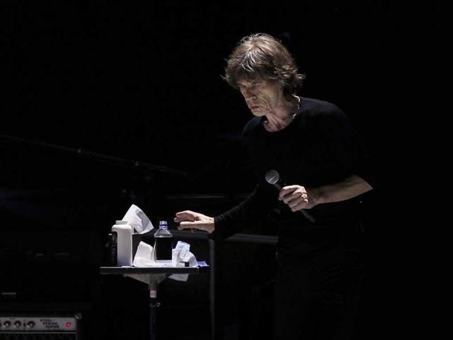 Mick Jagger reaches for a bottle of water as he performs onstage during the Rolling Stones final concert of their "50 and Counting Tour" in Newark, New Jersey. (Reuters)