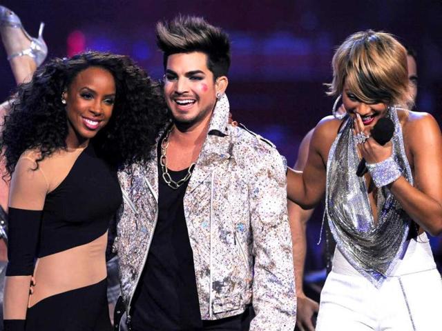 Kelly Rowland, left, Adam Lambert, center, and Keri Hilson are seen on stage at VH1 Divas at the Shrine Auditorium in Los Angeles. AP photo