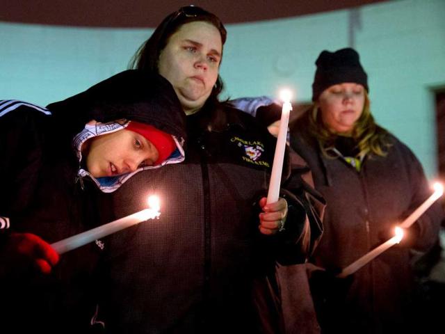 With tears in his eyes, 11-year-old David Clarence leans on his aunt, Jennifer Walton, as they stand in silent reflection during a vigil in Omaha Nebraska, held for victims of the Sandy Hook School in Connecticut shooting. AP photo