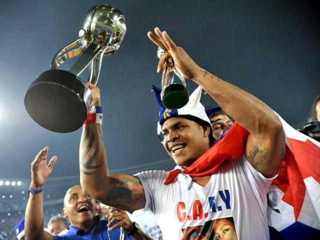 Colombian Millonarios player from Panama Roman Torres celebrates with the trophy after winning the Colombian League final football match against Deportivo Independiente Medellin at El Campin stadium in Bogota. AFP photo