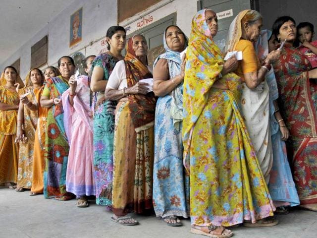 Indian women stand in queue to cast their votes for the second phase of Gujarat state assembly elections in Ahmedabad. An estimated 70% cast their ballots in the second and final phase of polling held in 95 constituences of the state. (AP Photo)
