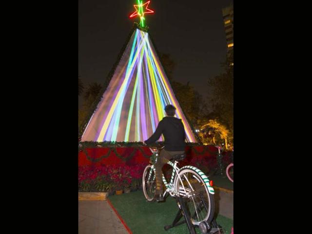 Teenager pedals a stationary bicycles generating electricty to maintain illumination for a Christmas Tree at the Abraham Lincoln Park in Mexico City. AFP photo